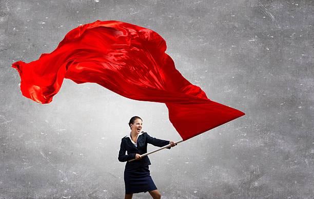 Woman waving red flag . Mixed media stock photo