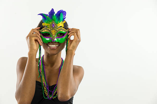 Woman wearing Mardi Gras mask with big smile 2 Woman wearing Mardi Gras mask with big smile 2 mardi gras women stock pictures, royalty-free photos & images