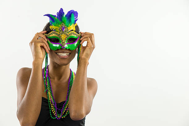 Woman wearing Mardi Gras mask with big smile Woman wearing Mardi Gras mask with big smile mardi gras women stock pictures, royalty-free photos & images