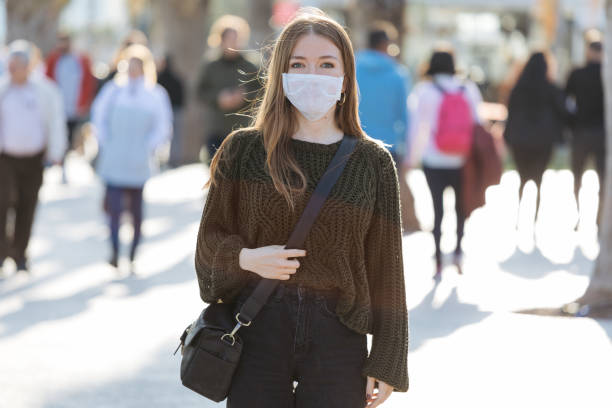 Woman wearing mask to avoid infectious diseases stock photo