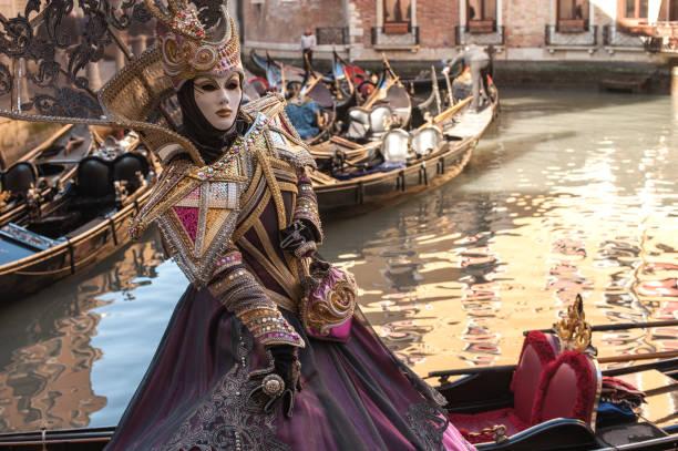 Woman Wearing Mystic Elegant Mask at Carnival in Venice stock photo