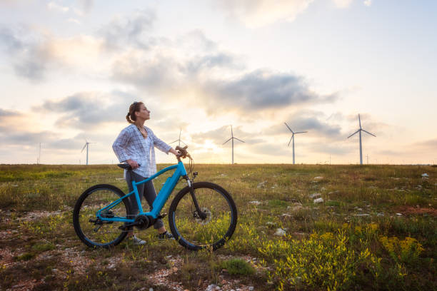 Woman with a bike in the nature stock photo