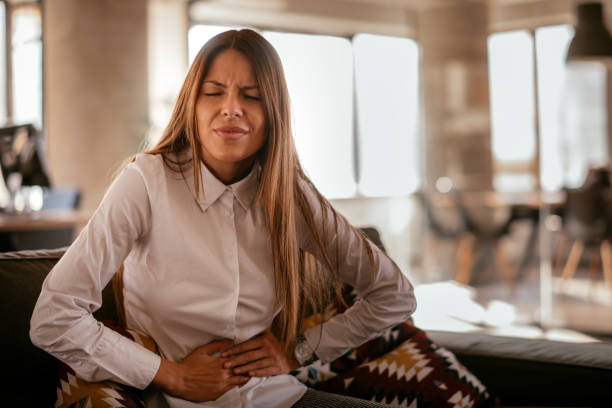 Woman with a stomach ache stock photo