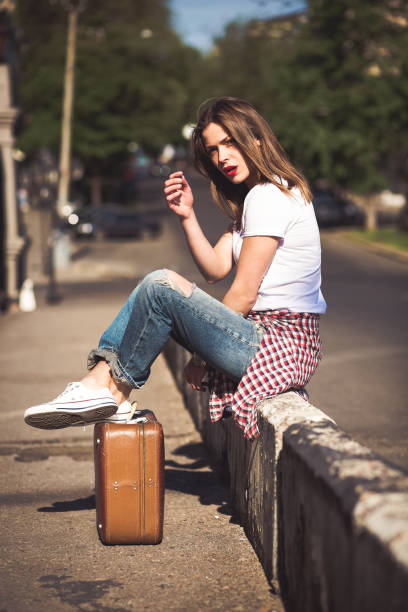 Woman with a suitcase in the city stock photo