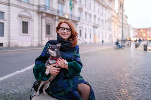 Woman with chihuahua in the city stock photo