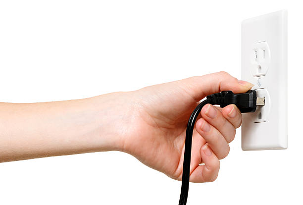 Woman with Electrical Outlet Plug on White  wired stock pictures, royalty-free photos & images