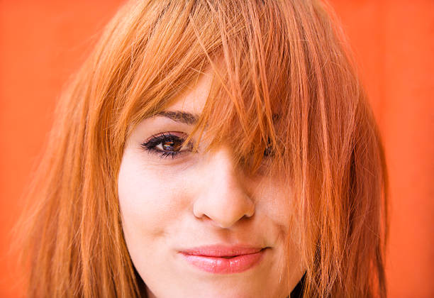 Woman with exasperated expression Young redheaded woman looking at viewer with funny expression. bangs hair stock pictures, royalty-free photos & images