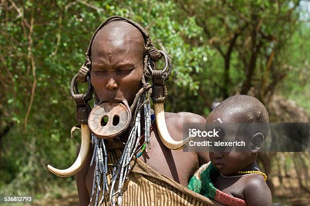 Woman with her baby of the Mursi tribe.