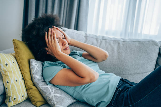 Woman with high fever at home. stock photo