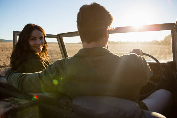 Woman with man in off road vehicle on landscape Woman with man in off road vehicle on landscape during sunny day southern africa stock pictures, royalty-free photos & images