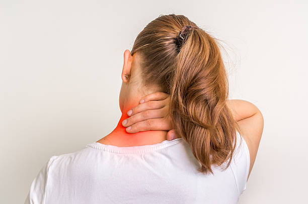 Woman with muscle injury having pain in her neck stock photo
