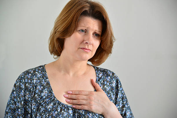 Woman with pain in  chest, angina stock photo