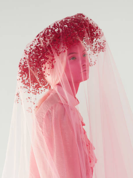 Woman with pink skin, pink wreath and clothes Woman with pink skin make-up, pink wreath, veil and top surreal photos stock pictures, royalty-free photos & images