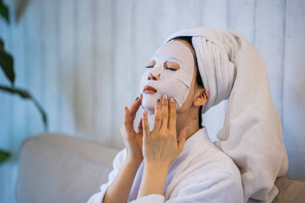 Woman with purifying mask on her face stock photo