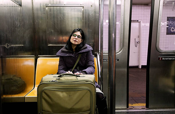 woman with suitcase in new-york subway - subway snapshot stockfoto's en -beelden