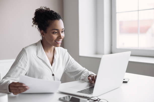 Woman working from home. Businesswoman using laptop in office stock photo