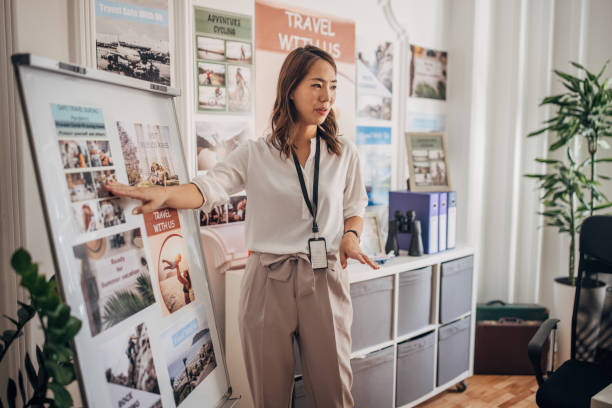 Woman working in travel agency stock photo