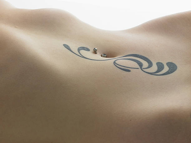 Woman's belly tattoo. stock photo