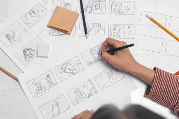 Woman's hand draws a storyboard for a film or cartoon. The artist animator creates sketches for the comics. stock photo