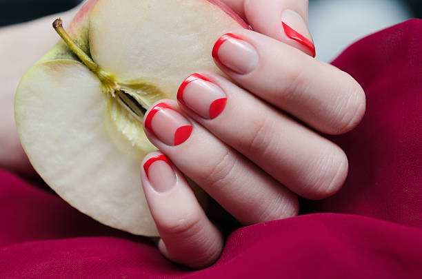 Woman's hand with red french manicure. stock photo