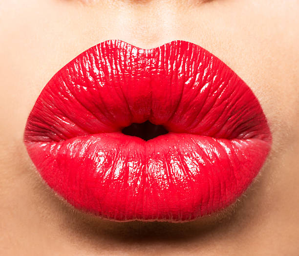 Woman's lips with red lipstick and  kiss gesture stock photo