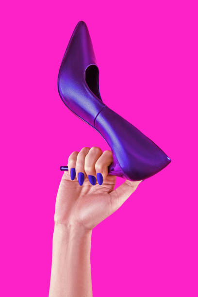 Womans power poster on pink background. Woman hand holding high heels shoe. Creative poster for sale or buisiness. Copy space for design stock photo