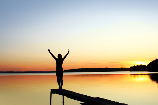 Woman with Raised Hands Standing at Edge of a Dock on a Sun Set Lake. Canon 5D, XXXL. Inspirational Concept
