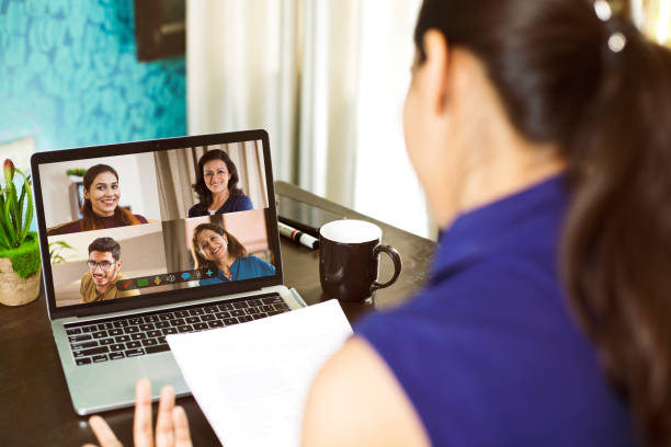 Women attending business video call from home Women attending business video call meeting using laptop at home web cam adult stock pictures, royalty-free photos & images
