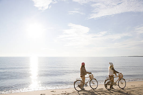 Women by the sea with bicycles  cape cod stock pictures, royalty-free photos & images