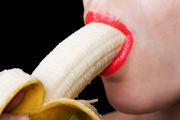 Women eating banana stock photo