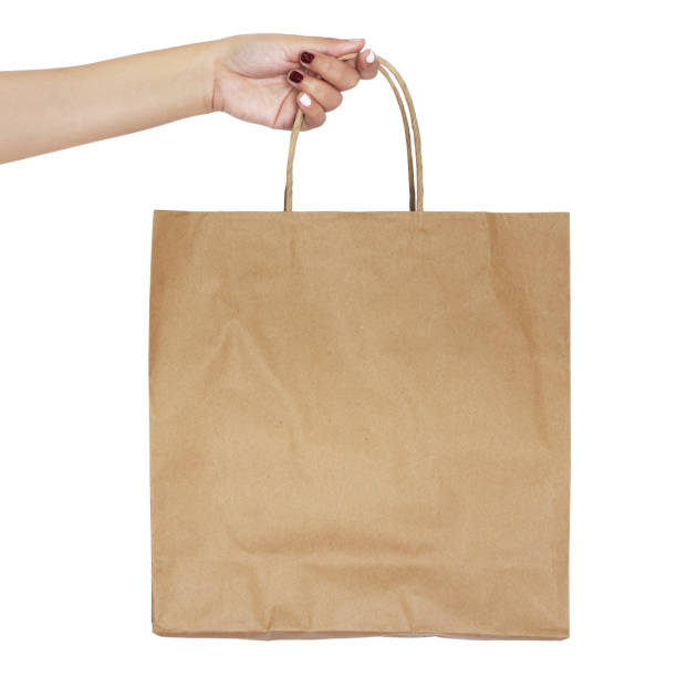 women hand holding paper shopping bag isolated on white background.sqaure image - paper bag craft imagens e fotografias de stock