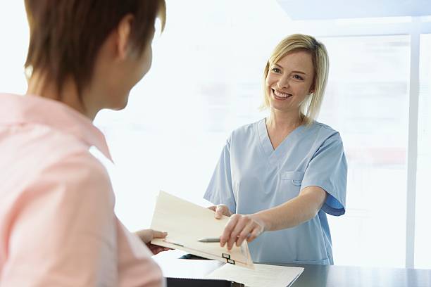 Women in a medical office Women in a medical office hotel reception photos stock pictures, royalty-free photos & images