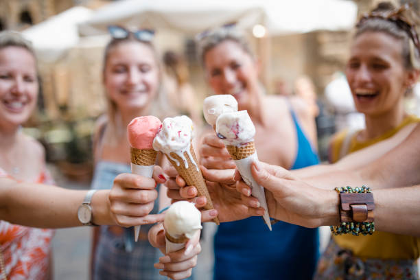Women Keeping Cool in Volterra Small group of women are eating ice cream in Volterra, Italy. party social event stock pictures, royalty-free photos & images