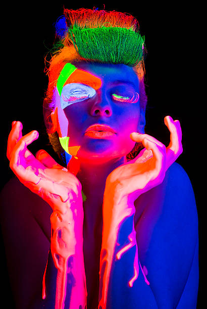 Women Portrait in Ultraviolet Light Young women portrait in Ultraviolet Light with Multi Colored makeup and hairstyle on black background  paint neon color neon light ultraviolet light stock pictures, royalty-free photos & images