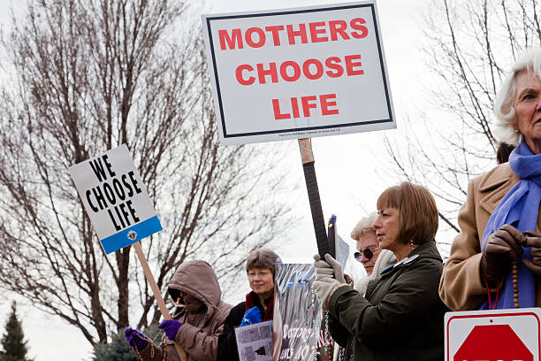Women protesting against abortion Boise, Idaho, USA - March, 9 2011: Women protesting against abortion outside a family planning center abortion protest stock pictures, royalty-free photos & images