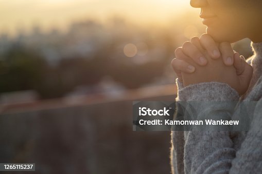 istock Women raise their hands to ask for blessing from God. 1265115237