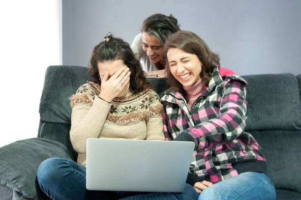 Women using laptop at home sofa stock photo
