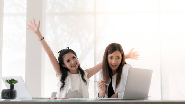 Women working together with happy and smiling in the office interior. stock photo