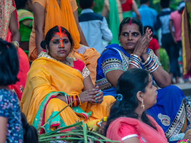 Women worshiping April 11,2019. Kolkata, India. Indian Devotee women worshiping River Ganga at Princep ghat. chhath stock pictures, royalty-free photos & images