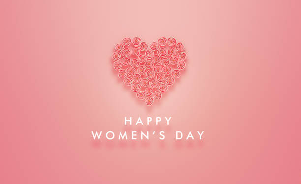 Happy Women's Day message written below a heart which is made of pink roses on pink background. Horizontal composition with copy space. Women's Day concept.
