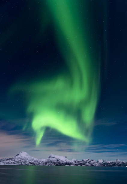 Wonderful green aurora borealis over Lofoten landscape in northern Norway stock photo