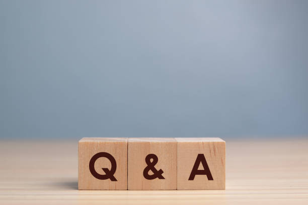 wood block cube with alphabet Q&A on wooden table,Questions and answers concept. stock photo