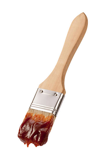 Wood Brush with Juicy Barbecue Sauce  isolated stock photo