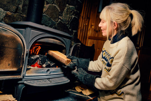 wood burning stove - idosos aquecedor imagens e fotografias de stock
