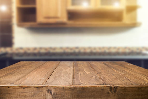 Wood desk space and blurred of kitchen background. Wood desk space and blurred of kitchen background. for product display montage. business presentation.Wood desk space and blurred of kitchen background. for product display montage. business presentation. bench stock pictures, royalty-free photos & images