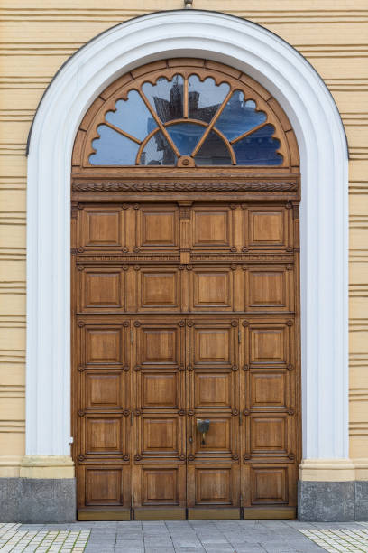 Wooden arched door in the classical style. The Architecture Wooden arched door in the classical style. The Architecture brown front main door stock pictures, royalty-free photos & images