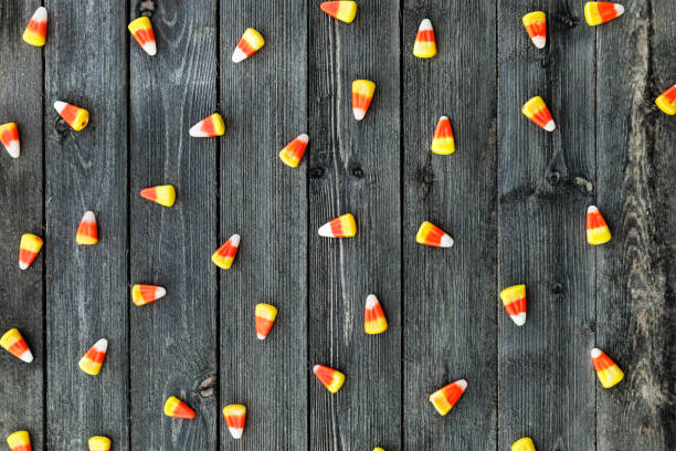 Wooden Background With Candy Corn For Halloween stock photo