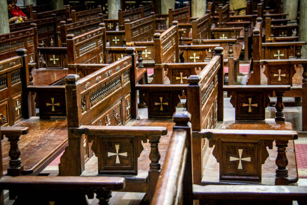 Wooden benches decorated by crosses in the Hanging Church in Coptic Cairo, Egypt Interior view of the Hanging Church in Cairo, Egypt coptic stock pictures, royalty-free photos & images