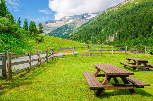 Wooden benches to picnic in Alpine valley, Austria stock photo