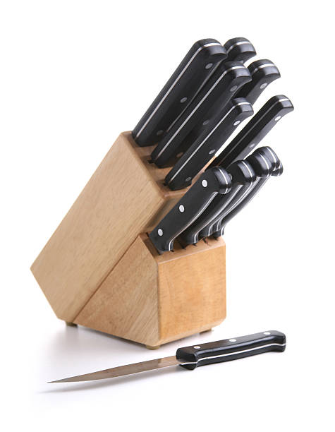 A wooden block and knife set on a white background stock photo